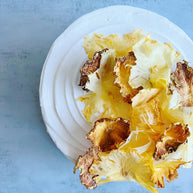 Custom cakes Honolulu by an italian pastry chef. This cake is a pineapple chiffon cake. It is made of vanilla sponge, white chocolate chantilly filling, fresh pineapple and decorated with dried pineapple flowers.