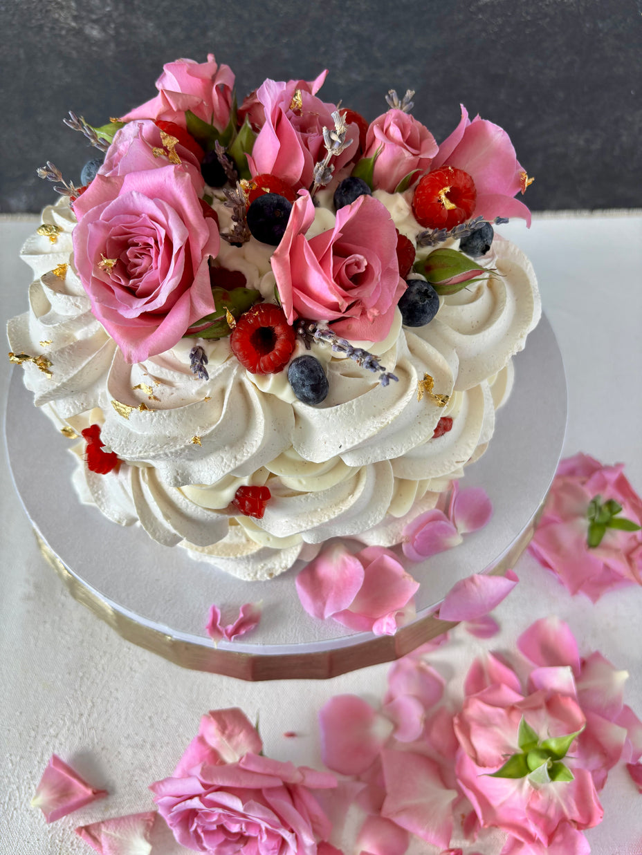 Custom Cakes for Every Occasion. Vanilla Pavlova cake in Honolulu. This vanilla pavlova is made with crispy meringue layers, white chocolate chantilly filling and decorated with fresh roses, lavender and fresh berries.