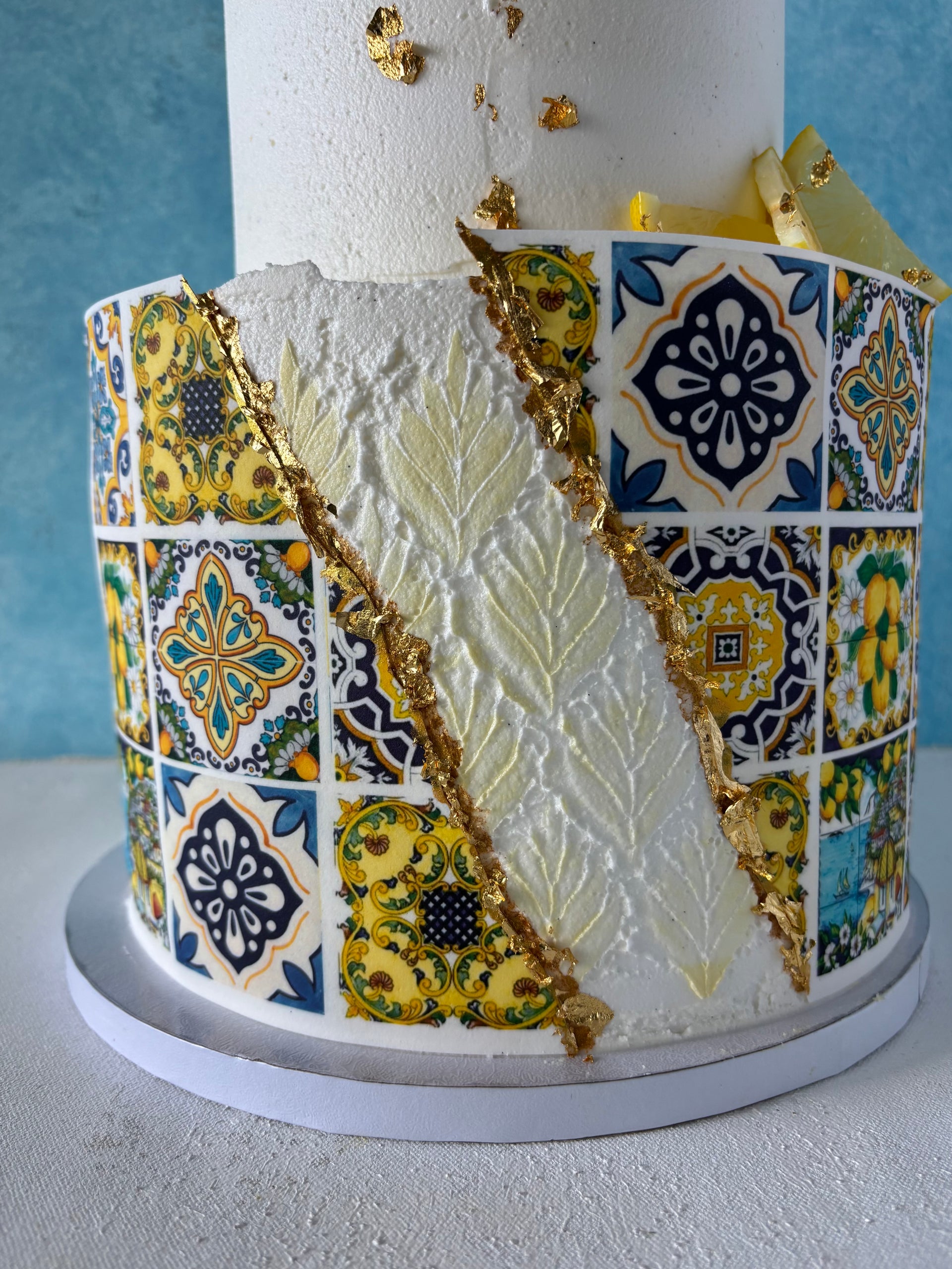 Wedding Cakes Oahu. Italian Amalfi Coast tiles wedding cake, two tiers, chiffon cake, lemon curd, fresh lemons, swiss vanilla buttercream frosting.