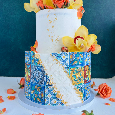 Wedding cake Honolulu. Dolce e Gabbana wedding cake. Italian tiles wedding cake with fresh orchids and fresh roses. Two-tiered cake with vanilla buttercream frosting.