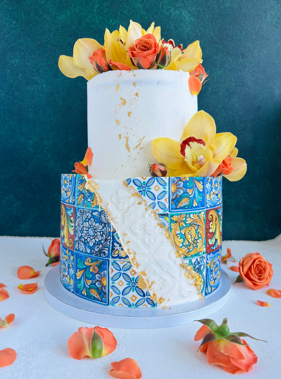 Wedding cake Honolulu. Dolce e Gabbana wedding cake. Italian tiles wedding cake with fresh orchids and fresh roses. Two-tiered cake with vanilla buttercream frosting.