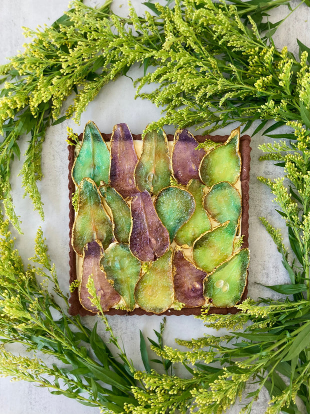 Tarts in Honolulu, Oahu. Chocolate tart shell, hazelnut cream filling, glass pears, gold finish. Italian pastry chef's caramelized pears tart, with pastry cream filling, decorated with hand-painted candied pears.