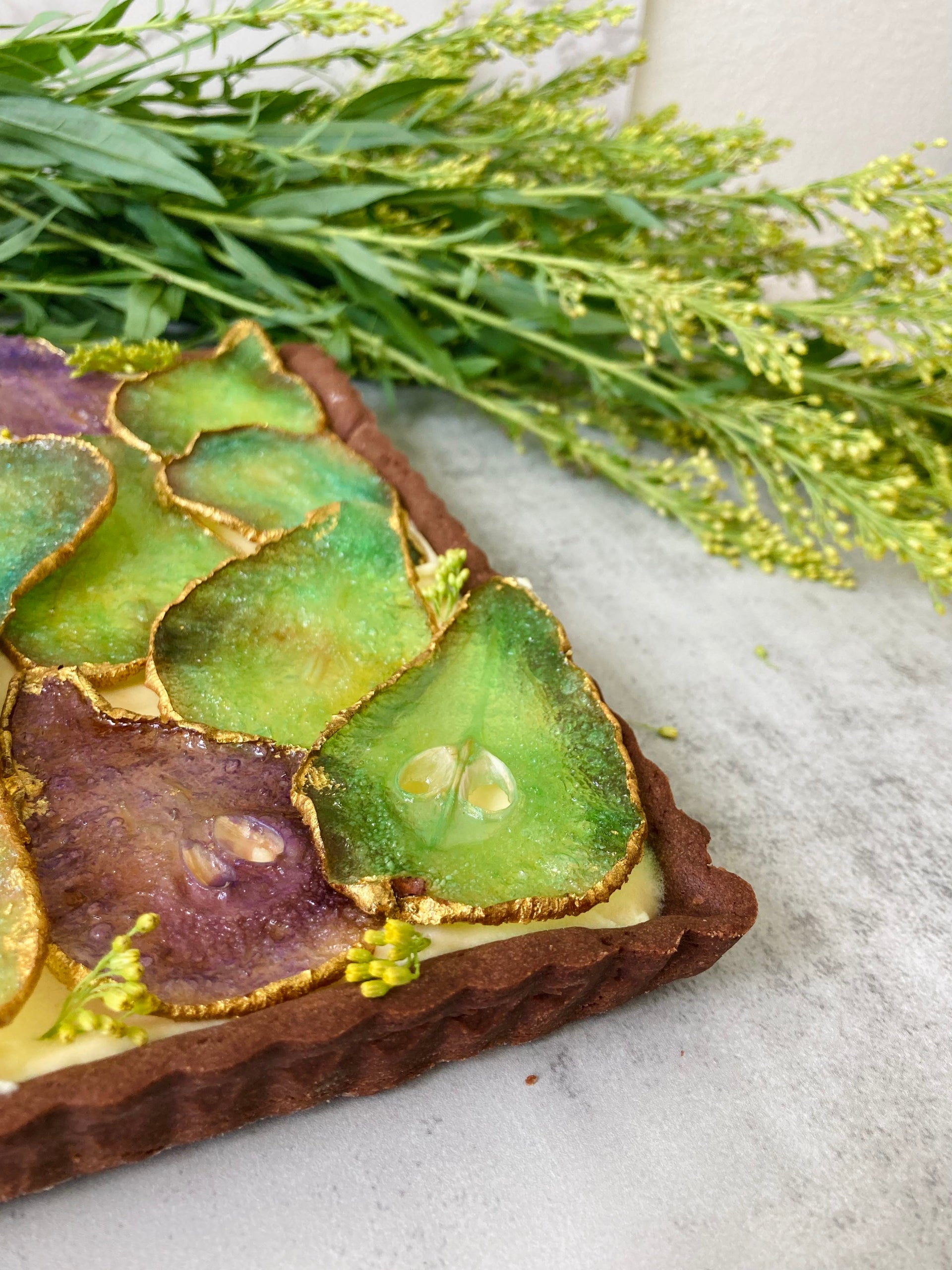 Tarts in Honolulu, Oahu. Chocolate tart shell, hazelnut cream filling, glass pears, gold finish. Caramelized pears tart, with pastry cream filling by italian pastry chef.